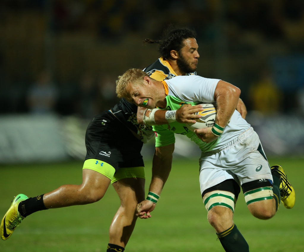 Sevens Academy's captain Kyle Brown (green and white) tackled by a player from Penguins (yellow and dark blue). Photo credit: Singapore Cricket Club