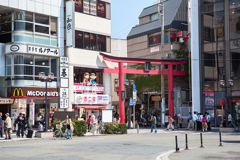 Torii at the entrance of shopping town is near the rail station square of the city. Photo © Kekyalyaynen | Shutterstock