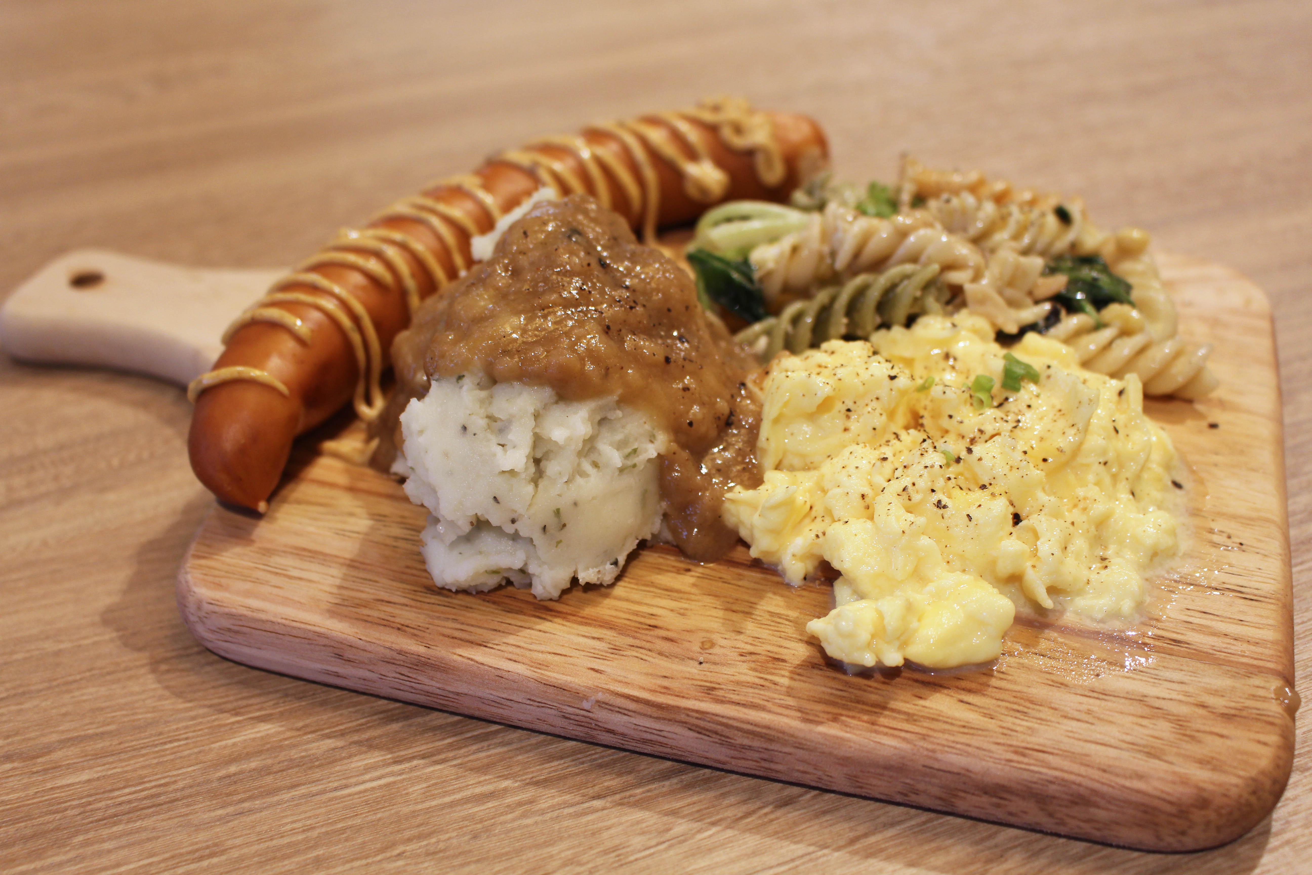Breakfast Platter with scrambled eggs, mashed potatoes, sausage and pasta salad 