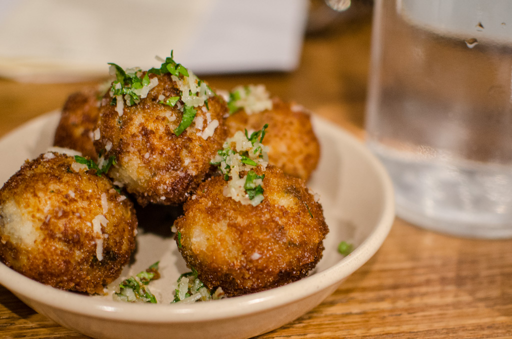 At Julio's, these arancini balls of gooey goodness are filled with mushrooms spinach, feta cheese, truffles and parmesan with a shell-thin crust. Best eaten piping hot. Photo © Justin Teo. 